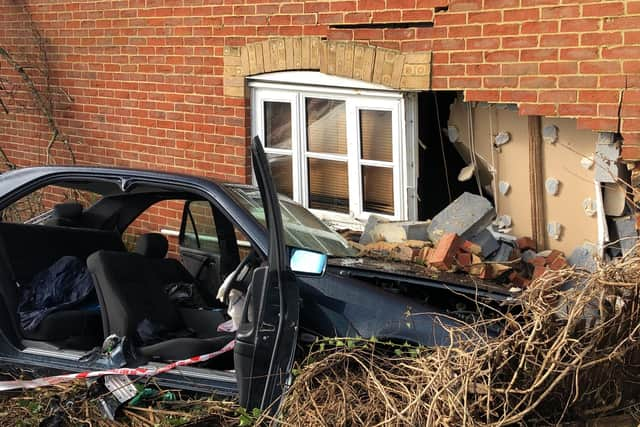 Firefighters had to remove the doors to help free the trapped woman, who police said suffered minor injuries. Photo: Tom Cotterill