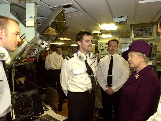 Her Majesty the Queen being introduced to members of the 'Ops Room', on board HMS Invincible 27th April 2004. Picture: Malcolm Wells (042169-77)