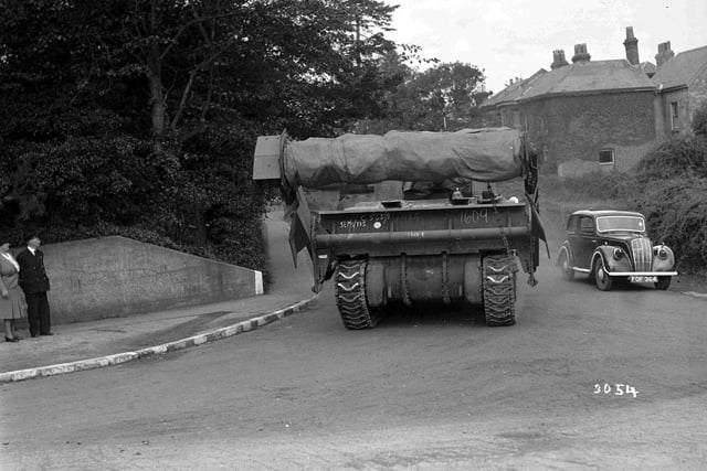 Flail tank driving past car