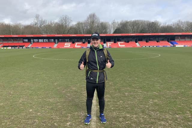Nathan Richardson is running to all 92 stadiums in the top four tiers of English football, and will soon make his way to Fratton Park. Pictured here at Salford City FC