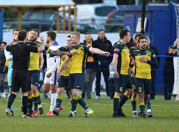 Moneyfields players surround referee Jordan McRitchie following midfielder Callum Glen's first-half sending off Picture: Neil Marshall