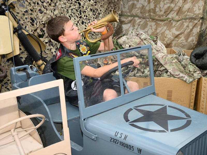 Charlie Underwood blows his bugle in a toy jeep.Picture: Keith Woodland (260521-39)