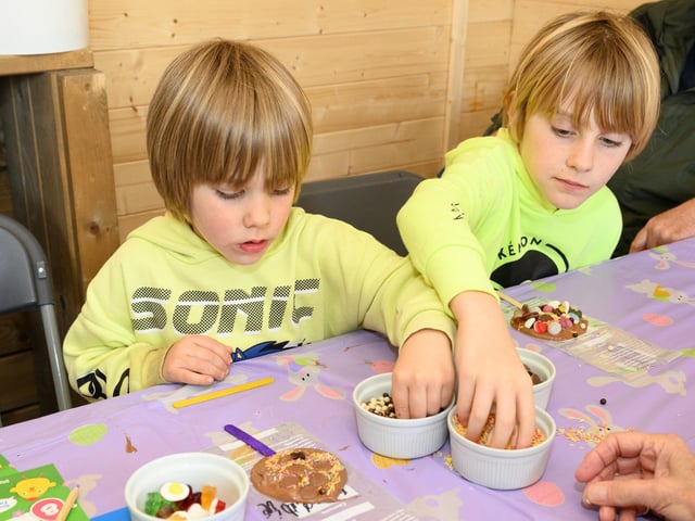 Pictured is: Freddie and Stevie Groves help themselves to more sweets to decorate their lollipopsPicture: Keith Woodland (300321-6)