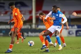 Charlie Bell holds off Peterborough's Idris Kanu in the Papa John's Trophy last season. Picture: Nigel Keene/ProSportsImages