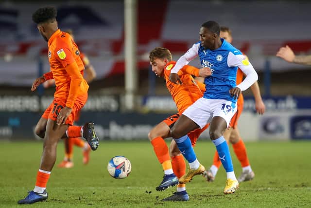Charlie Bell holds off Peterborough's Idris Kanu in the Papa John's Trophy last season. Picture: Nigel Keene/ProSportsImages