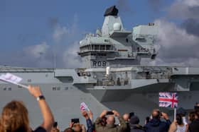 HMS Queen Elizabeth leaving Portsmouth September 7, 2022. Pictured: People waving at HMS Queen Elizabeth as it goes past the Round Tower, Old Portsmouth. Picture: Habibur Rahman.
