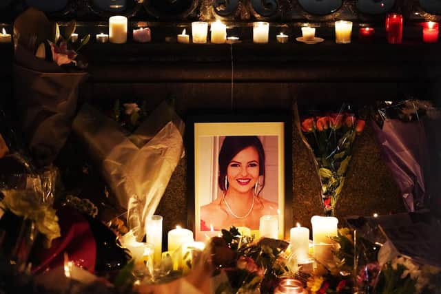 A photograph of Ashling Murphy among flowers and candles at a make-shift shrine during a vigil in her memory at Leinster House, Dublin on Friday 
Picture: Brian Lawless/PA Wire