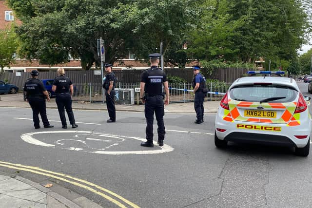 Officers gathering outside Alexandra Road, at the junction of Lake Road following a robbery. Photo: Tom Cotterill