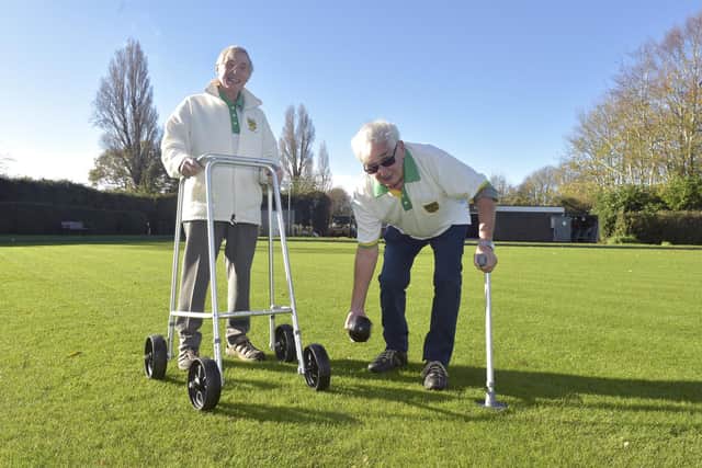 Members of the Bridgemary Bowling Club have come together to recycle zimmer frames and crutches to adapt them into usable mobility aids to help keep older people playing bowls despite mobility issues. Pictured is: (l-r) Barrie Hudson and Ron Barrett demonstrate the upcycled zimmer frame and crutches.
Picture: Sarah Standing (171122-6461)
