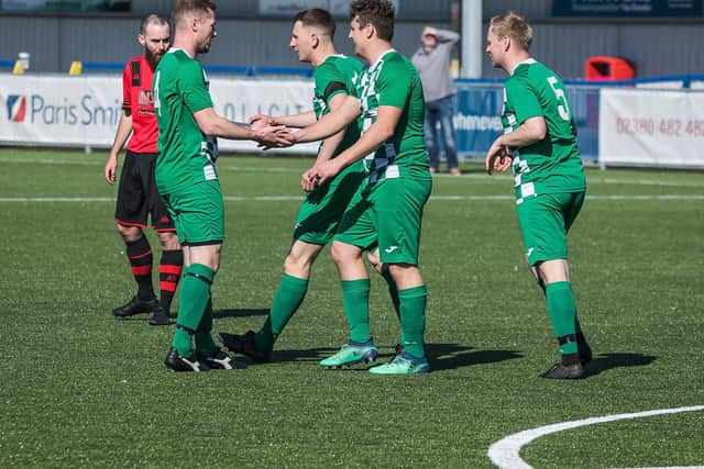 Harry Potter is congratulated after one of his early two goals against Meon. Pic: Mike Cooter.