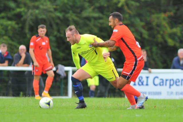 Horndean's Connor Duffin (yellow) with Portchester defender Curt Da Costa. Picture: Martyn White