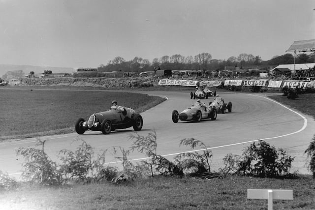 15th May 1951:  D Poore in an Alfa (25), leading B Bira (1914 - 1985) in an Osca (5) and G Farina in a Maserati (3) at Woodcote Corner during the Festival of Britain race, Goodwood.  (Photo by Fisher/Central Press/Getty Images)