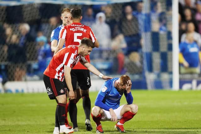 Tom Naylor is consoled following Pompey's play-off elimination at the hands of Sunderland last season