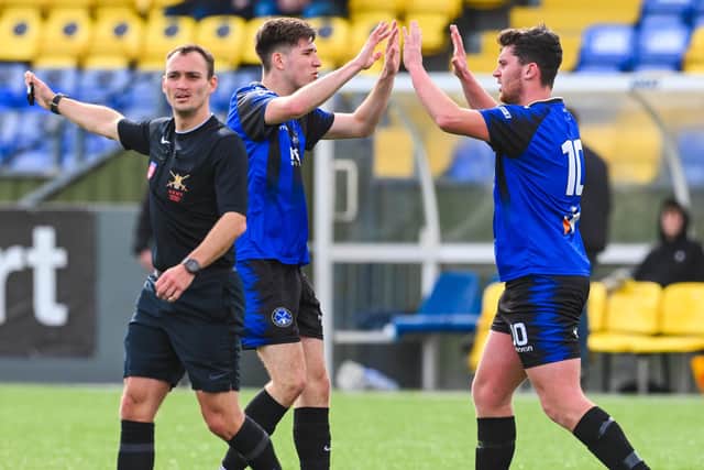 Liam Gouge, right, celebrates one of his two goals against Winchester Castle. Picture by Richard Murray