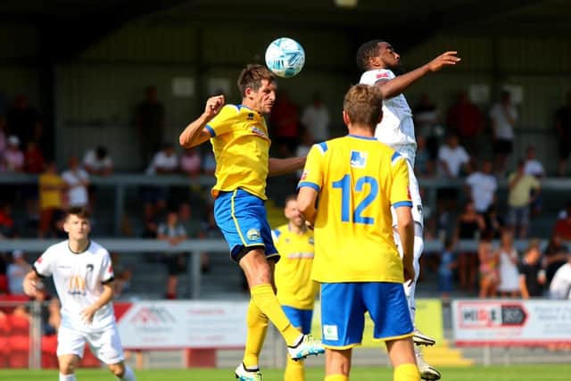 Danny Hollands rises for a header during Gosport's defeat at Weston. Picture by Tom Phillips