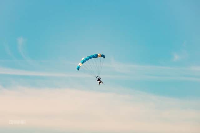 Supporters of the Rainbow Centre in Fareham took on a daring skydive to raise funds. Pictured: One of the fundraisers jumping with a tandem instructor. Picture by: Steven J Phyall from Zooming Photography