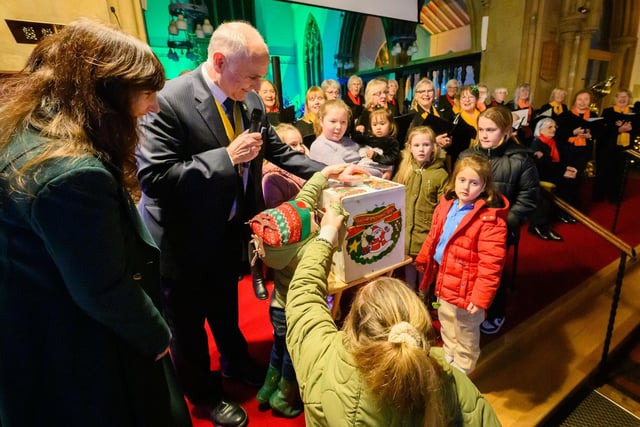 Pictured is: Deputy Mayor, Councillor Richard Earle and Deputy Mayoress, Debbie Sherman were helped by children from the congregation to help turn on the lights

Picture: Keith Woodland (071221-26)