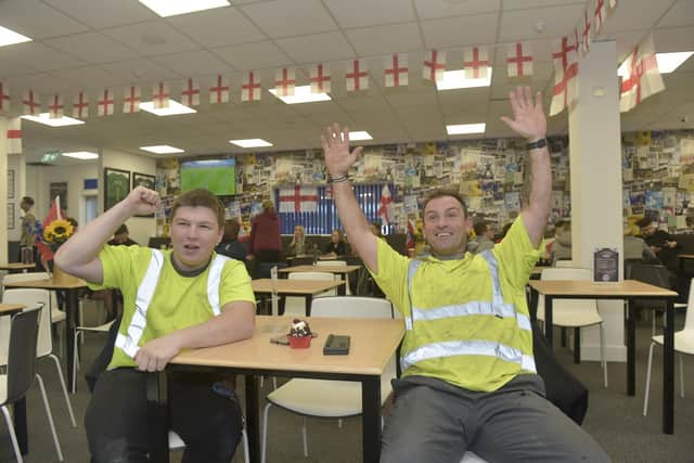 England fans come to the Legends Lounge at Portsmouth FC on Monday, November 21 to watch the England v Iran World Cup match. Pictured is: (l-r) Harvey Capps (17) with his dad Allan Capps (43) from Southern Structures.Picture: Sarah Standing (211122-6876)