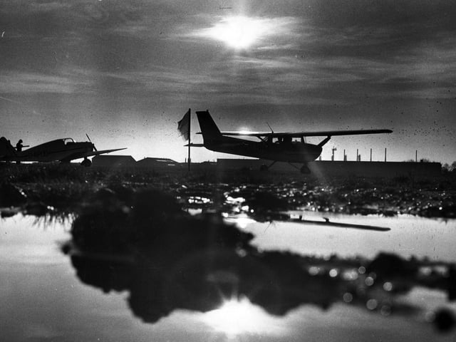 The sun sets on Portsmouth Airport, December 31, 1973.