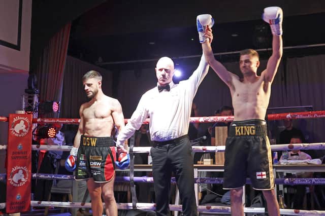 Matt King, right, has his arm raised following his knock-out victory. Picture: Barry Zee