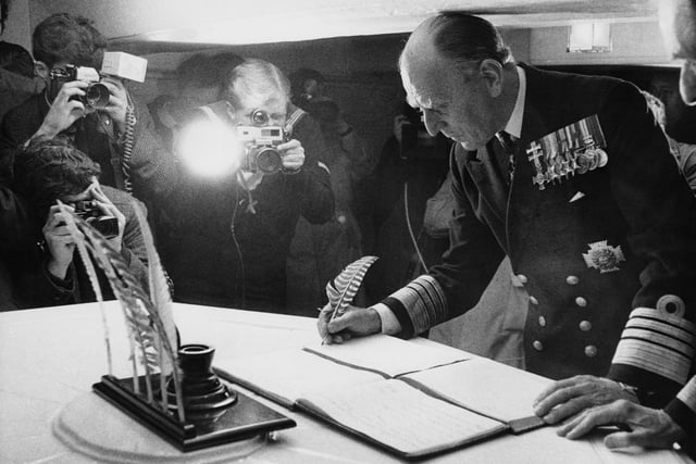 Admiral Sir John Bush (1914 - 2013) of the Royal Navy, Commander-in-Chief Western Fleet, signs the visitors' book of Nelson's flagship 'HMS Victory' at Portsmouth, UK, 22nd May 1969. Bush is visiting the famous vessel with a group of NATO admirals.  (Photo by Keystone/Hulton Archive/Getty Images)