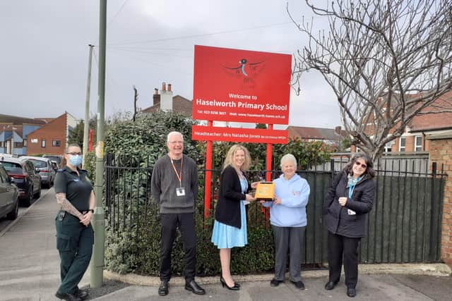 Elizabeth handing over the donation at Haselworth Primary School.
