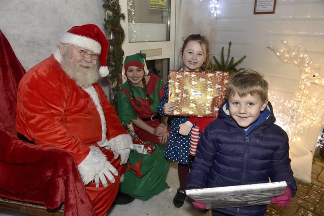 Lee-on-the-Solent Christmas lights were switched on in the High Street on Friday, November 24./ppPictured is: Cousins Penny Ware (5) from Gosport and Henry Ware (4) from Fareham, meeting Father Christmas. Picture: Sarah Standing (241123-2263)