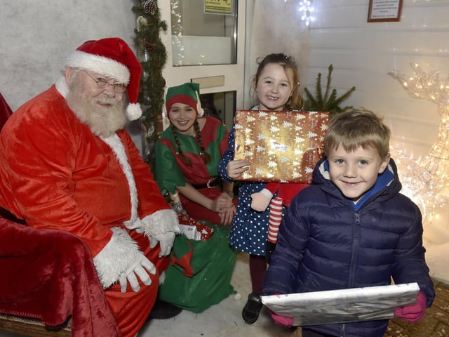 Lee-on-the-Solent Christmas lights were switched on in the High Street on Friday, November 24.Pictured is: Cousins Penny Ware (5) from Gosport and Henry Ware (4) from Fareham, meeting Father Christmas.Picture: Sarah Standing (241123-2263)