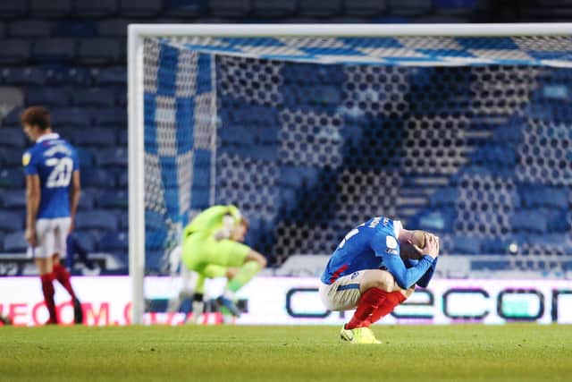 Andy Cannon is dejected after Chuks Aneke puts the game beyond Pompey's reach after grabbing Charlton's second in their 2-0 success. Picture: Joe Pepler
