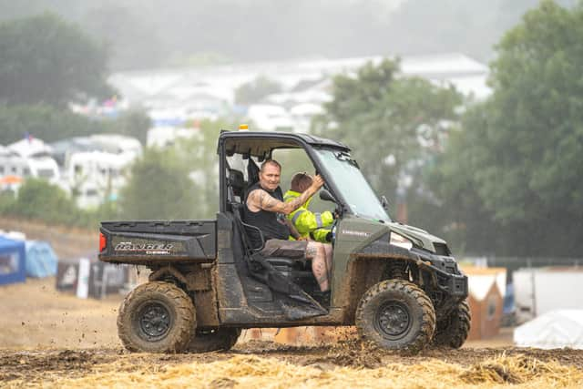 Staff rush back and forth up and down the main field to get the festival open. Picture: Andy Hornby