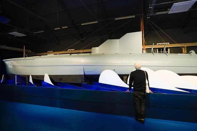 A person looks at MTB (Motor Torpedo Boat)  331 during a press preview for The Night Hunters: The Royal Navy's Coastal Forces at War exhibition at the Explosion Museum of Naval Firepower in Gosport, Hampshire. Picture date: Wednesday October 6, 2021. Photo:: Andrew Matthews/PA Wire