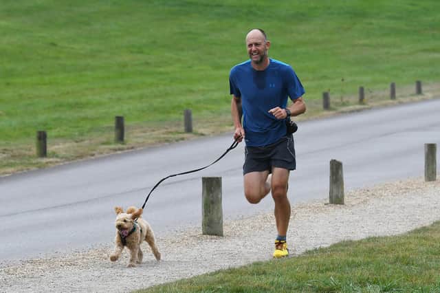 A Fareham parkrunner and his canine chum at Cams Hall Estate.
Picture: Neil Marshall