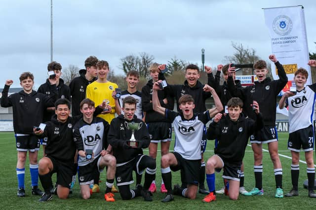 Captain Daniel Andrews (holding cup) celebrates with his Fleur de Lys Victory team after the Under-16 GEC Marconi Invitation Cup final win against Cowplain Youth. Picture: Chris Moorhouse