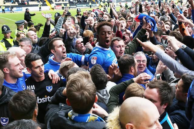 Jamal Lowe is mobbed by visiting Pompey fans after firing the Blues to promotion at Meadow Lane in April 2017. Picture: Joe Pepler