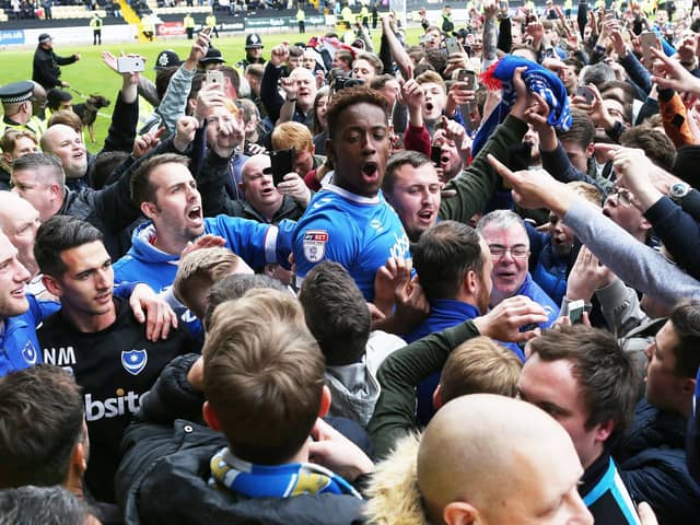 Jamal Lowe is mobbed by visiting Pompey fans after firing the Blues to promotion at Meadow Lane in April 2017. Picture: Joe Pepler