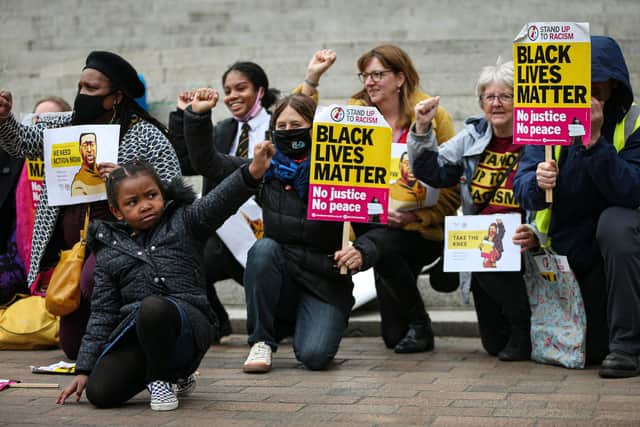 Nala-Paris Mbah, 5, left. Black Lives Matter campaigners take a knee in Guildhall Square, Portsmouth, in 2021 on the first anniversary of the death of George Floyd at the hands of police in Minneapolis, US
Picture: Chris Moorhouse (jpns 250521-17)