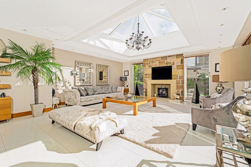 The lounge area features exposed natural stonework, a stone fireplace and large glass cupola, allowing an amazing amount of natural light into the space.