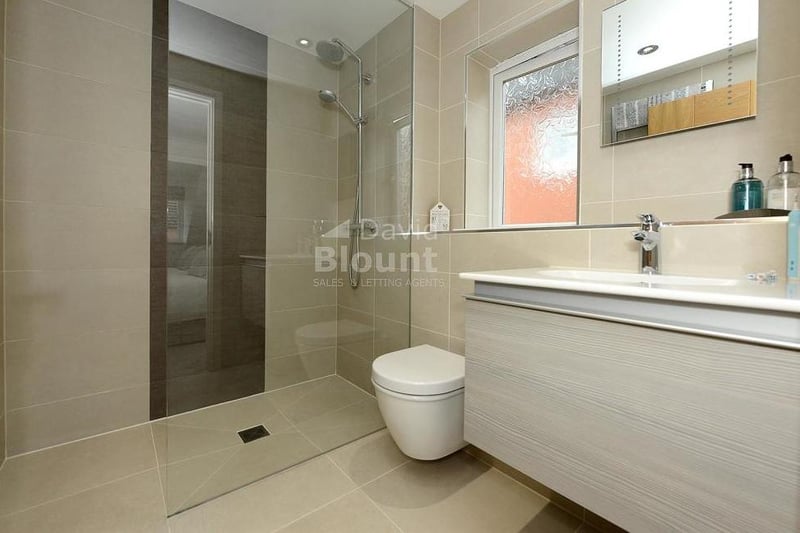 Attached to the main bedroom is this en suite shower room, which has been fully re-fitted. It features a walk-in shower, Duravit counter-top basin, WC and upright chrome radiator.