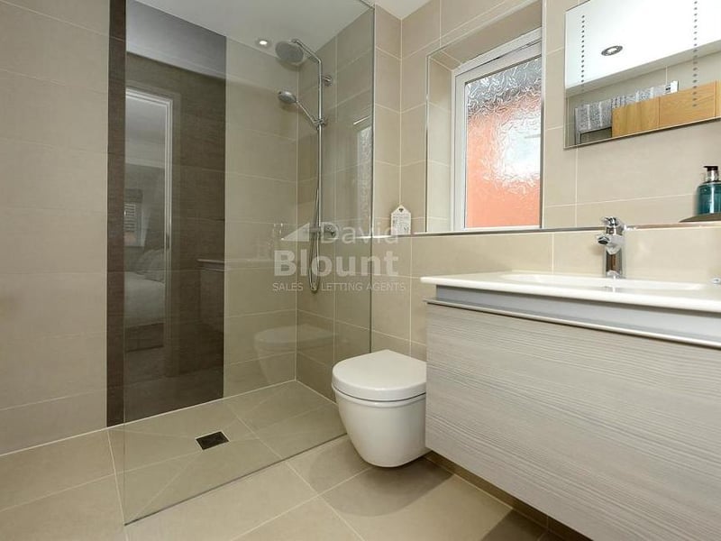 Attached to the main bedroom is this en suite shower room, which has been fully re-fitted. It features a walk-in shower, Duravit counter-top basin, WC and upright chrome radiator.