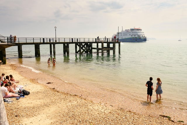 Pictured is: People enjoy a paddle near the pier at Old Portsmouth.