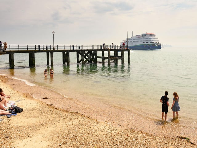 Pictured is: People enjoy a paddle near the pier at Old Portsmouth.