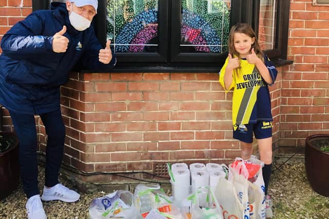 Chris Webb with Izzy Martin and the food she bought to help Gosport Borough's 'Feed A Family In Need' project