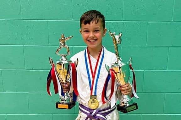 Harry Knight with his national kata and ippon kumite trophies he won in Nottingham