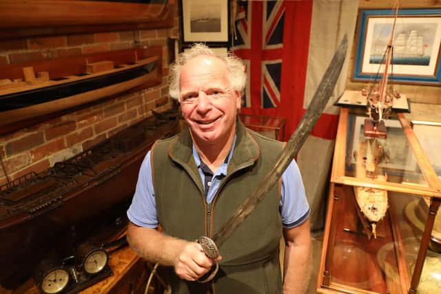 Charles Wallrock of Wick Antiques with Lord Nelson's sword that he is selling at the Chelsea Antiques Fair