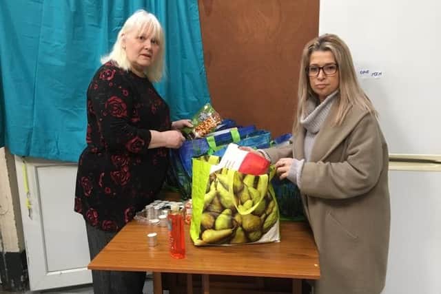 Jacobs Well in Gosport has had to temporarily close due to the issues surrounding the coronavirus. Pictured: Anne Hamilton, receptionist, and Lorraine Pottinger putting together a food parcel