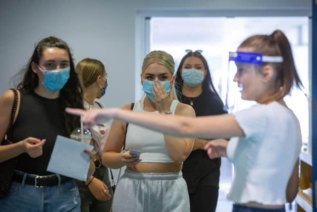 Portsmouth College students wearing masks are directed to where to collect their results.

Picture: Habibur Rahman
