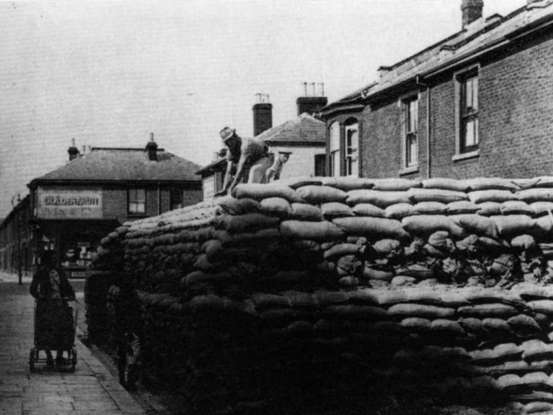 A sandbagged protected water tank. Can anyone recognise where this street location is?