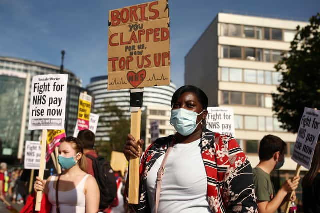 NHS workers march from St Thomas' Hospital to Downing Street, London, to demand a pay rise on July 29. Participants include the members of Unite, Keep Our NHS Public and Nurses United. PA wire