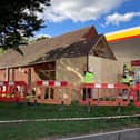 Workers repairing the Shell garage in Wickham after a car ploughed into it last night.