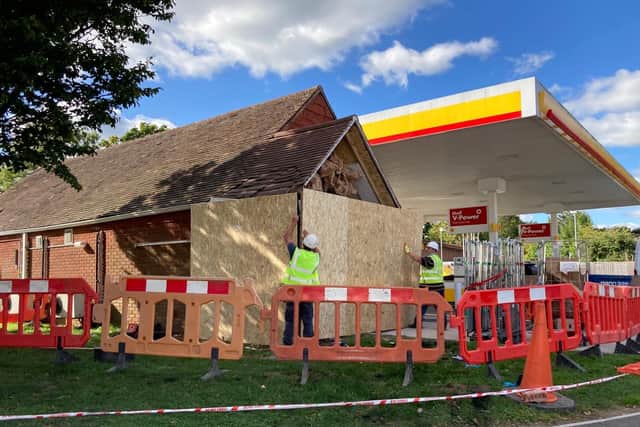 Workers repairing the Shell garage in Wickham after a car ploughed into it last night.